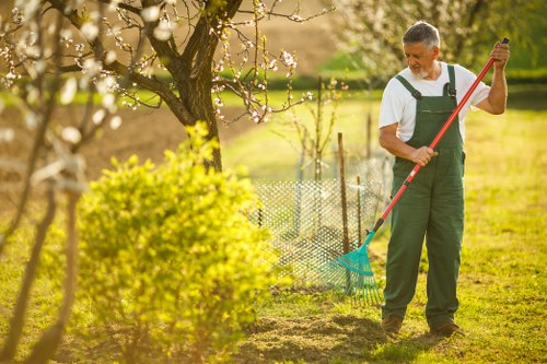 Professional landscapers using PPE during outdoor work in Chislehurst